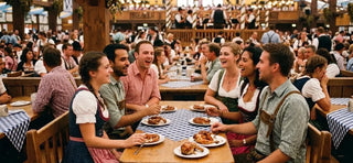 Friends enjoying traditional Bavarian food inside an Oktoberfest beer tent in Munich, demonstrating proper Oktoberfest etiquette and respectful festival dining customs.