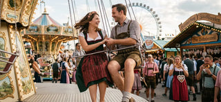 Couple enjoying a vintage swing ride at Oide Wiesn in traditional Dirndl and Lederhosen.