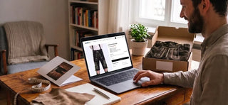 Man shopping for authentic lederhosen online, comparing fit, quality, and sizing before buying traditional Bavarian attire.