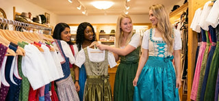 International women browsing dirndl dresses in a traditional Bavarian fashion boutique