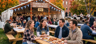 Visitors enjoying the Oktoberfest Festival in Connecticut, USA, with authentic German food, live Bavarian music, outdoor seating, and festive fall decorations.