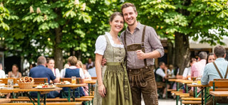 Dirndl and lederhosen showcased by a couple in authentic Bavarian Tracht attire.